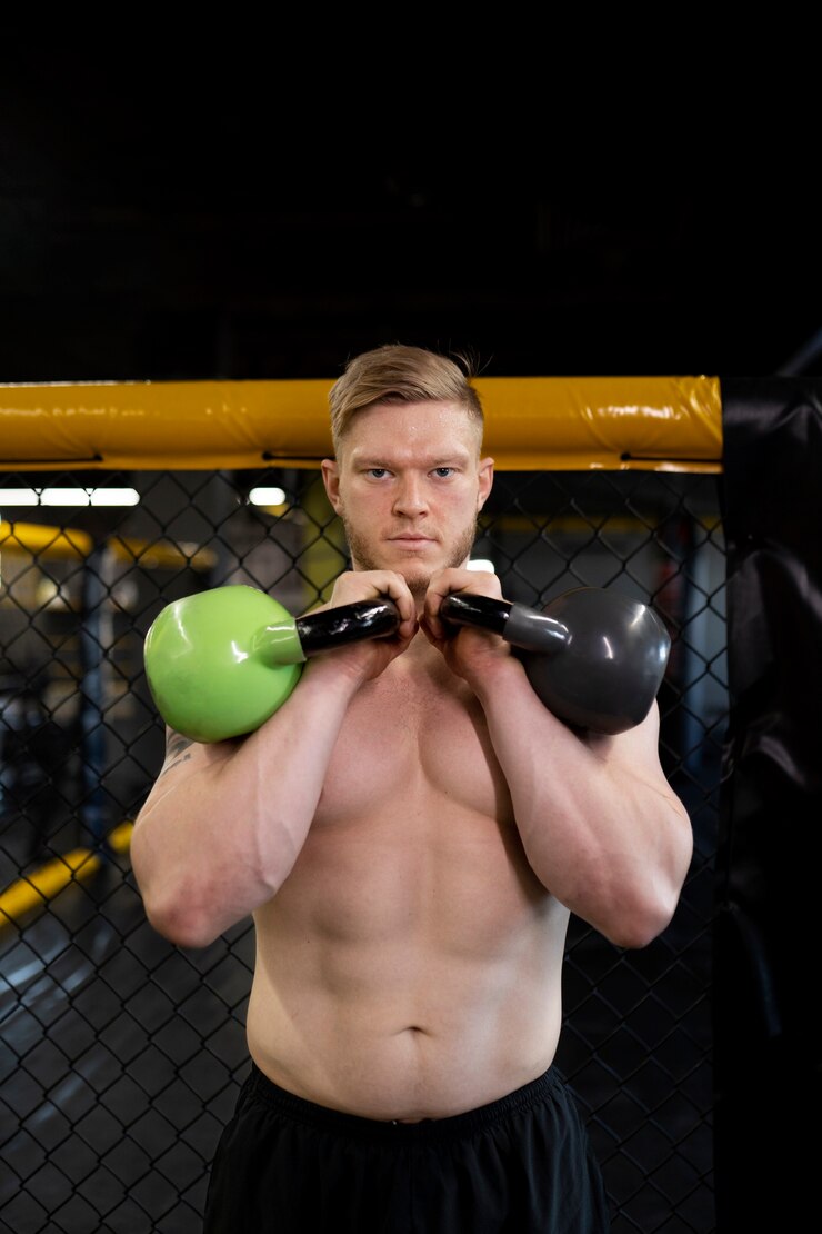 Free Photo man training with kettlebells front view