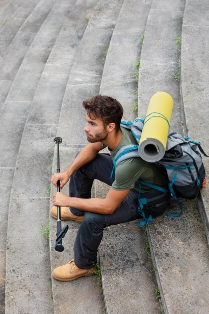 Man traveling alone in mutriku while having his essentials in a backpack