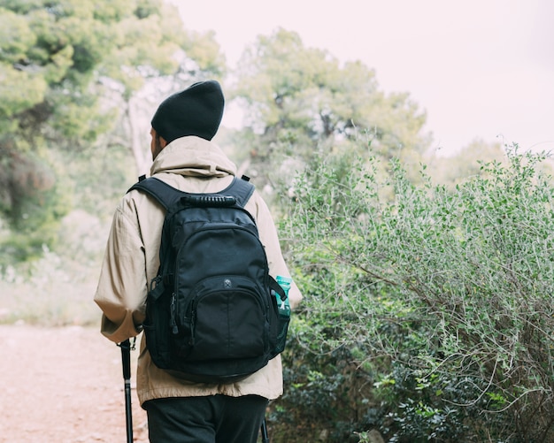 Free photo man trekking in mountains