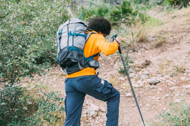 Free photo man trekking in mountains