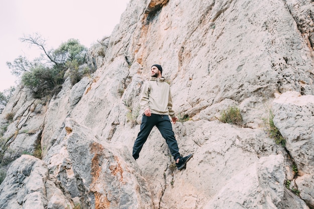 Free photo man trekking in mountains