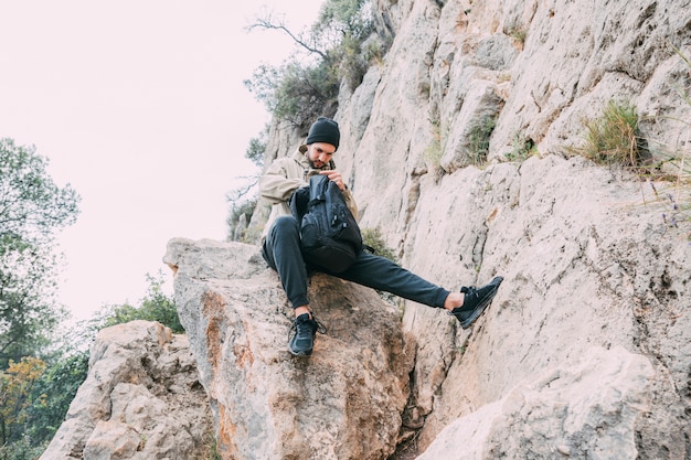 Free photo man trekking in mountains