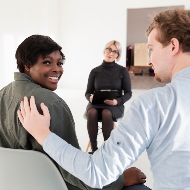 Man trying to console afro-american  female patient