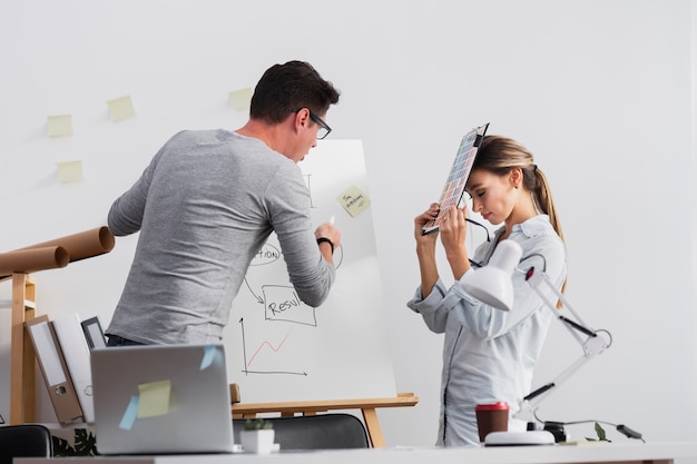 Man trying to explain diagram to female colleague