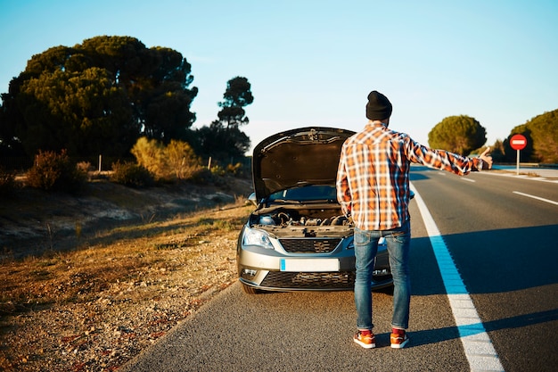 Man trying to get help with his broken car