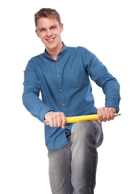 Man trying to split a giant pencil