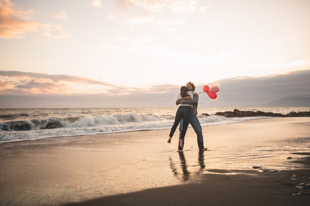 Man turning his girlfriend on herself in the air