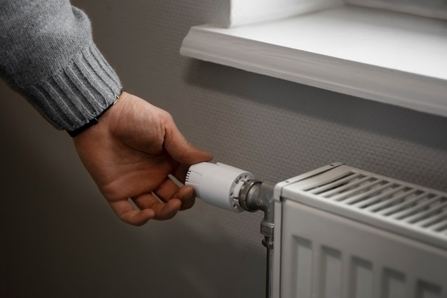 Man turning off radiator during energy crisis