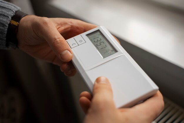 Man turning off thermostat during energy crisis