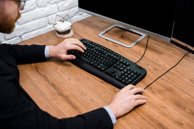 Man typing on keyboard close up
