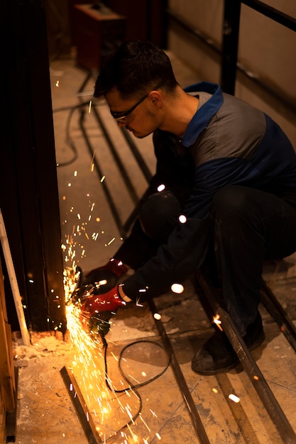 Man using angle grinder with sparks