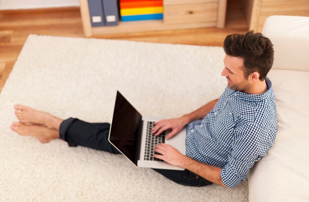 Man using contemporary laptop in living room