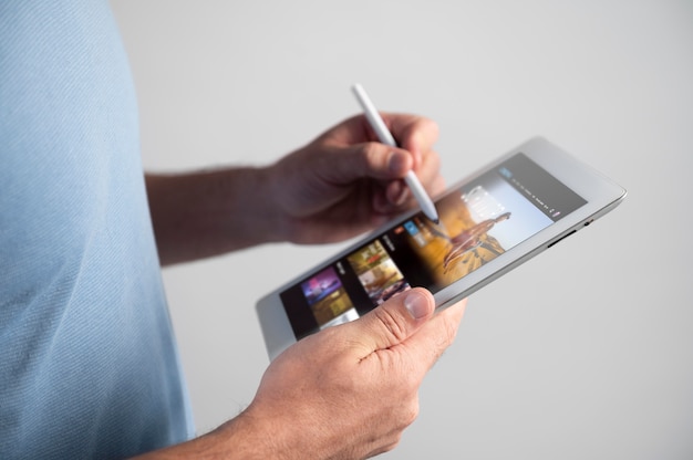 Man using a digital assistant on his tablet