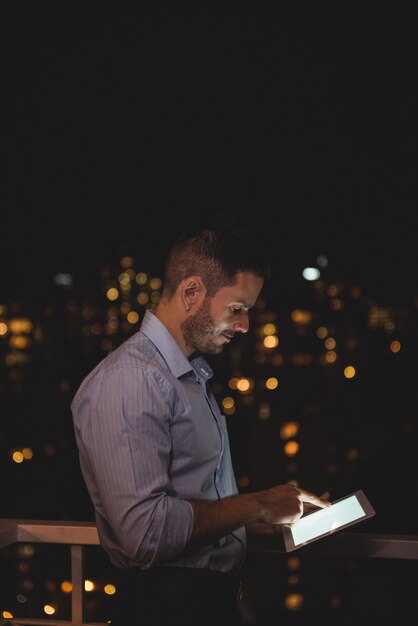 Man using digital tablet in the balcony