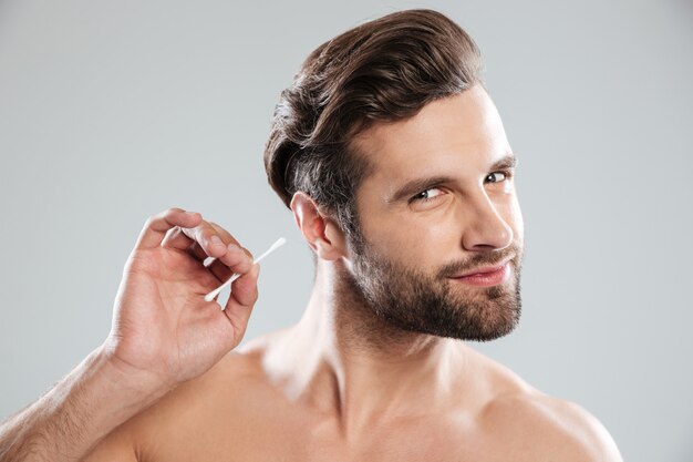 Man using ear sticks isolated