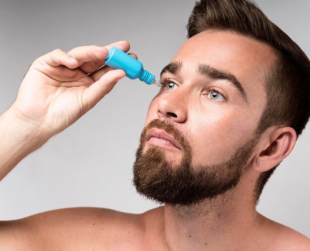 Man using eye drops