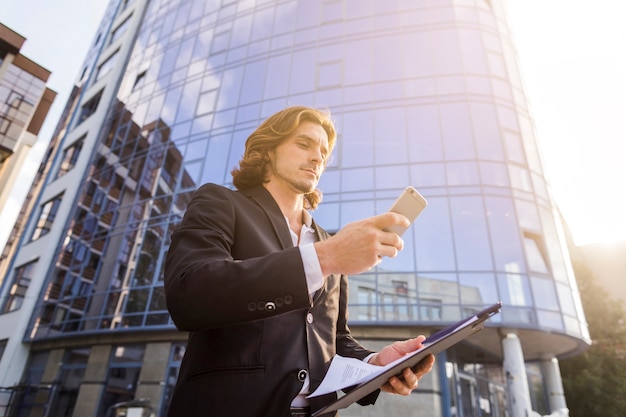 Man using his phone on a sunny morning