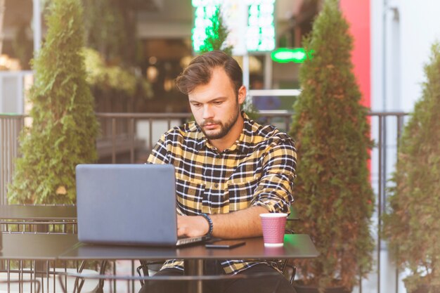 Man using laptop in coffee shop