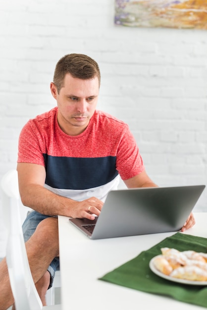 Man using laptop at home