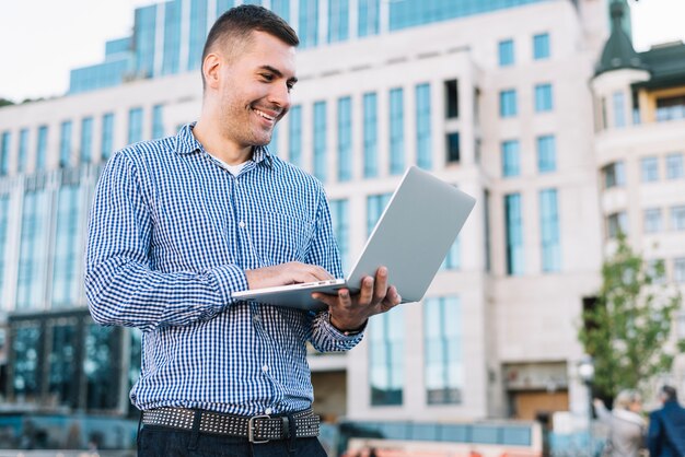 Man using laptop in urban environment