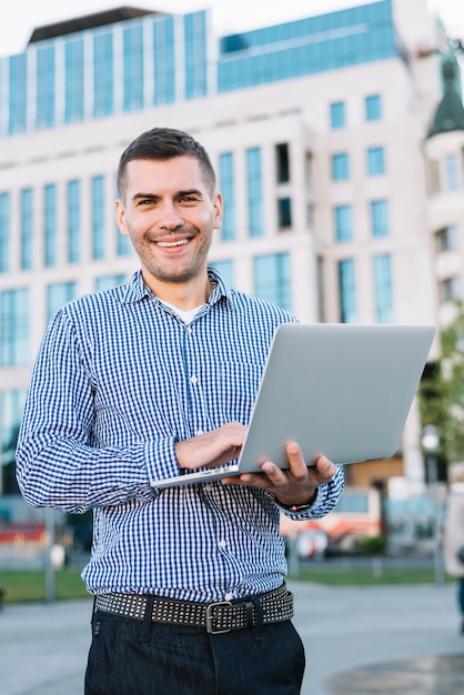 Man using laptop in urban environment