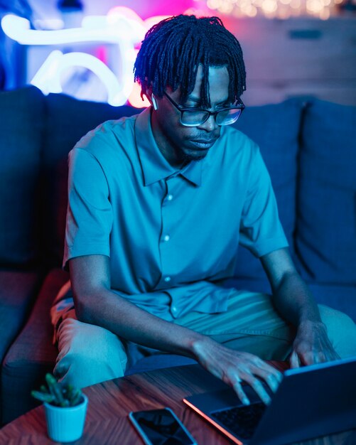 Man using laptop while on the couch at home