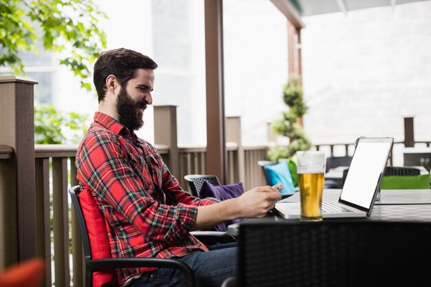 Man using mobile phone in bar