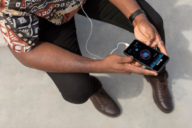 Man using modern smartphone with earphones