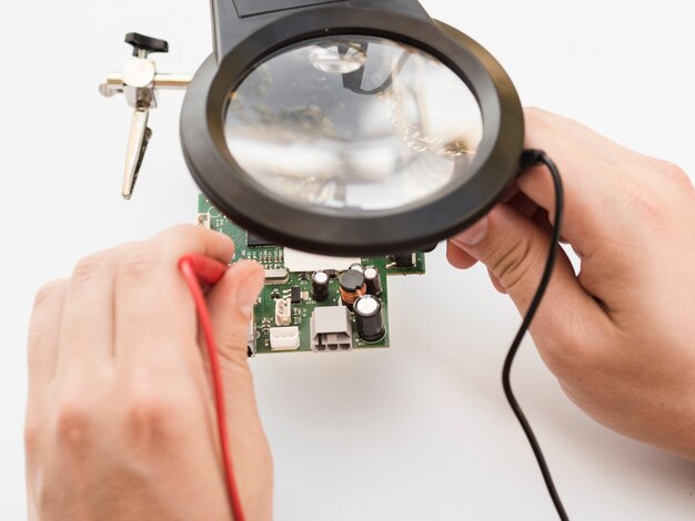 Man using multimeter to check board