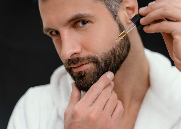 Man using natural oils for his face