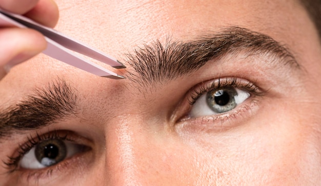 Man using a pair of tweezers close-up