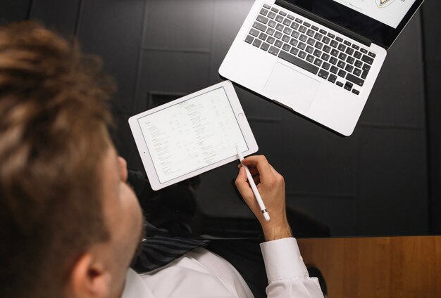 Man using pencil on tablet