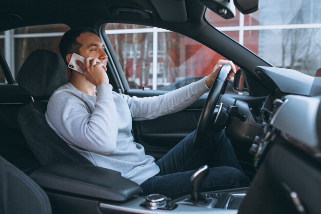 Человек с помощью телефона во время вождения