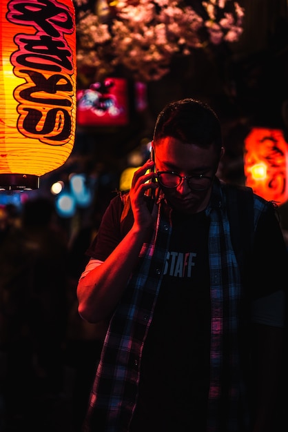 Man using phone while standing during night time