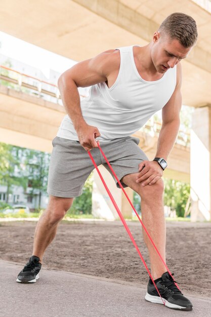 Man using a red stretching band