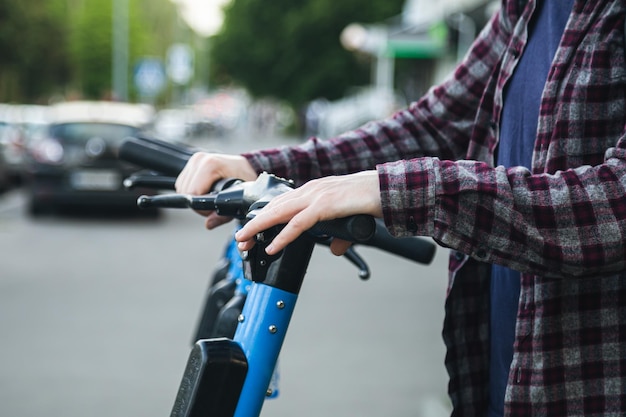 A man using a rental service with an escooter close up