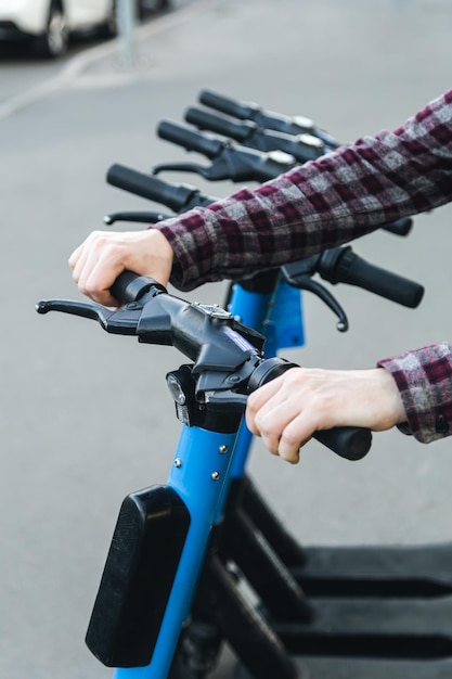 A man using a rental service with an escooter close up