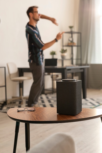 Free photo man using a smart speaker while dancing