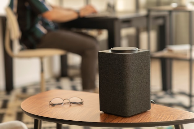 Man using a smart speaker while working