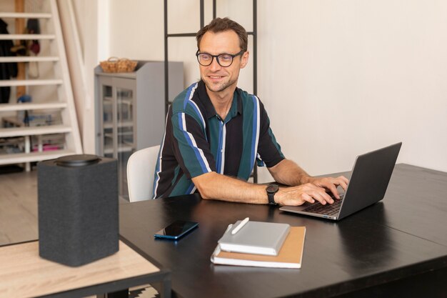 Man using a smart speaker while working