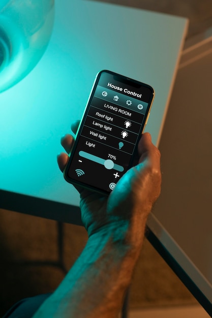 man using a smartphone in his automated home