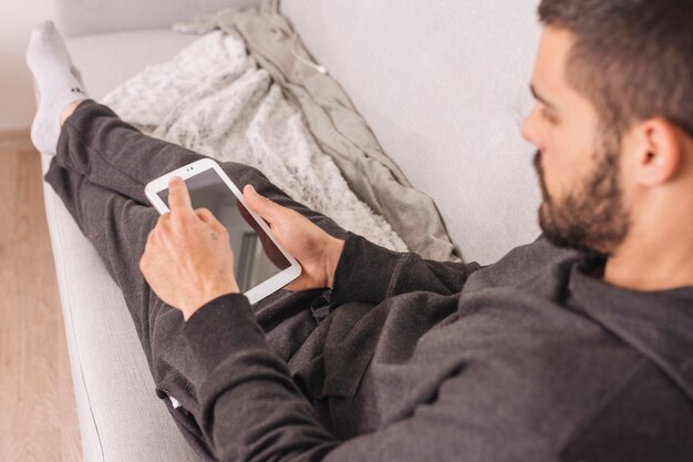 Man using smartphone at home