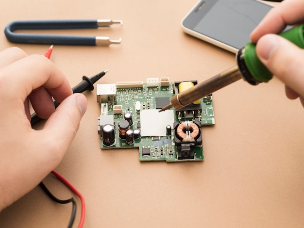 Man using soldering iron on circuit