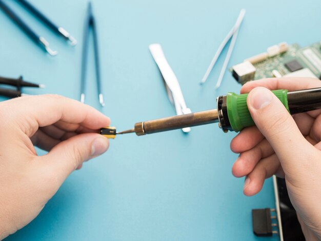 Man using a soldering iron to repair a component