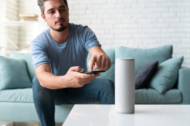 Man using a speaker digital assistant