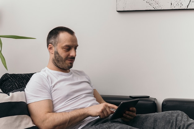 Man using tablet on couch