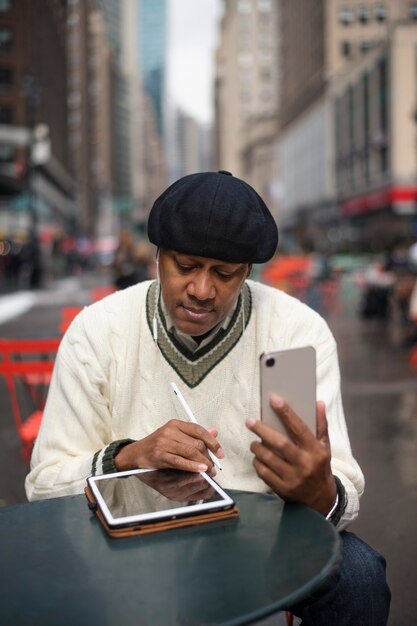 Man using technology while traveling in the city