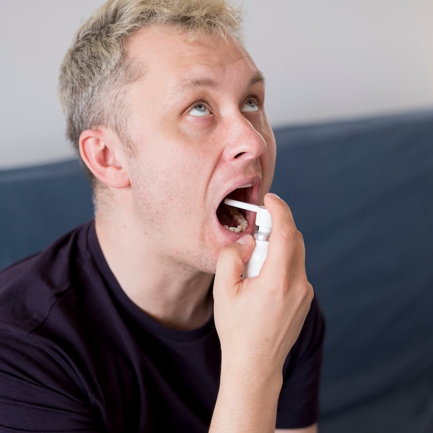 Man using treatment for sore throat