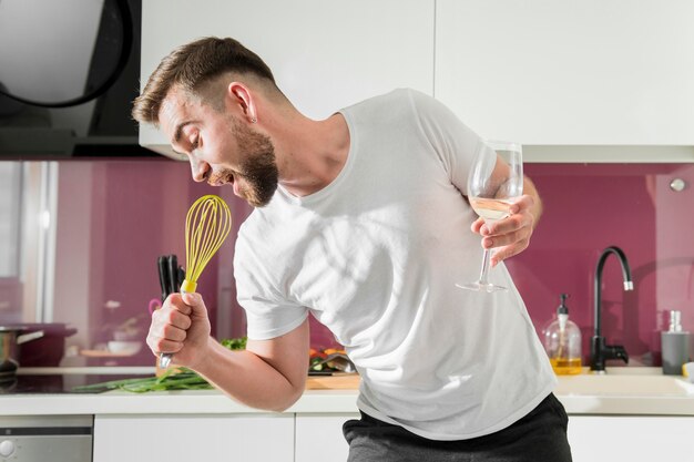 Man using whisk as a microphone