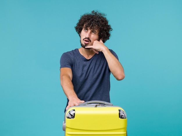 man in vacation in blue t-shirt posing on blue